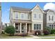 Well-maintained two-story house with a covered porch, manicured lawn, and a mix of siding and stone for added character at 4120 Overcup Oak Ln, Cary, NC 27519