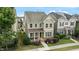 Charming two-story home with a covered front porch, landscaped yard, and green siding at 4120 Overcup Oak Ln, Cary, NC 27519