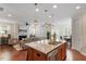 Open kitchen with granite counters, stainless appliances, an island, hardwood floors, and access to the living room at 4120 Overcup Oak Ln, Cary, NC 27519