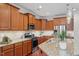 Kitchen featuring granite countertops, stainless appliances, lots of wooden cabinets, and a tile backsplash at 4120 Overcup Oak Ln, Cary, NC 27519