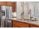 Island with granite countertops and a stainless steel refrigerator, dishwasher, and faucet at 4120 Overcup Oak Ln, Cary, NC 27519
