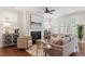 Cozy living room featuring a fireplace, plush seating, modern decor, and plenty of natural light at 4120 Overcup Oak Ln, Cary, NC 27519