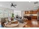 Open-concept living space seamlessly blending the living room, dining area, and kitchen with hardwood flooring at 4120 Overcup Oak Ln, Cary, NC 27519
