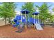 Community playground with modern blue play equipment and a soft, wood chip surface at 4120 Overcup Oak Ln, Cary, NC 27519