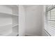 A walk-in closet has white walls and built-in shelves and hanging racks at 4120 Overcup Oak Ln, Cary, NC 27519