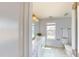 Bathroom with light blue walls, white vanity and toilet, and a window bringing in natural light at 421 Old Ride Dr, Holly Springs, NC 27540