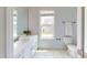 Bright bathroom with a white vanity, toilet, and a window that provides natural light and neighborhood views at 421 Old Ride Dr, Holly Springs, NC 27540
