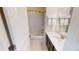 This bathroom features a shower over the tub and a modern vanity with a white countertop and dark cabinets at 421 Old Ride Dr, Holly Springs, NC 27540