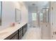 Modern bathroom with marble tile shower and dark wood vanity with white countertop at 421 Old Ride Dr, Holly Springs, NC 27540