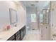 Modern bathroom with marble tile shower and dark wood vanity with white countertop at 421 Old Ride Dr, Holly Springs, NC 27540