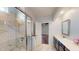 Modern bathroom with marble tile shower, white countertop, and open doorway to bedroom at 421 Old Ride Dr, Holly Springs, NC 27540
