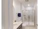 Bathroom featuring tiled walk-in shower with glass door and modern fixtures at 421 Old Ride Dr, Holly Springs, NC 27540