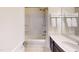This bathroom features a shower over the tub and a modern vanity with a white countertop and dark cabinets at 421 Old Ride Dr, Holly Springs, NC 27540