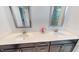 Double vanity bathroom with quartz countertops, framed mirrors, and brushed gold faucets at 421 Old Ride Dr, Holly Springs, NC 27540