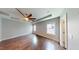 Spacious bedroom with tray ceiling, ceiling fan, hardwood floors, and neutral paint at 421 Old Ride Dr, Holly Springs, NC 27540