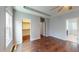 Large bedroom with walk-in closet, ensuite bathroom, hardwood floors, and natural light at 421 Old Ride Dr, Holly Springs, NC 27540