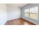 Bright bedroom features hardwood floors and a large window overlooking the landscape at 421 Old Ride Dr, Holly Springs, NC 27540