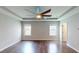 A large bedroom is shown with hardwood floors, a ceiling fan, and natural light at 421 Old Ride Dr, Holly Springs, NC 27540