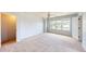 This bedroom boasts an ample closet, a ceiling fan, and a large window with views of the neighborhood at 421 Old Ride Dr, Holly Springs, NC 27540