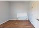 Bedroom with hardwood flooring, closet, and white headboard at 421 Old Ride Dr, Holly Springs, NC 27540