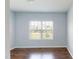 Sun-filled bedroom with hardwood floors and a large window at 421 Old Ride Dr, Holly Springs, NC 27540