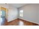 Cozy bedroom with wood floors, light walls, and a window at 421 Old Ride Dr, Holly Springs, NC 27540