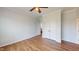 This light and bright bedroom features hardwood flooring, a ceiling fan, and an ample closet at 421 Old Ride Dr, Holly Springs, NC 27540