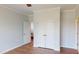 Empty bedroom with hardwood floors, neutral walls, crown molding, and an ensuite entrance at 421 Old Ride Dr, Holly Springs, NC 27540
