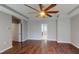 Primary bedroom featuring hardwood floors, a ceiling fan, walk-in closet, and ensuite bathroom at 421 Old Ride Dr, Holly Springs, NC 27540