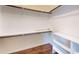 Walk-in closet with hardwood floors, built-in shelving, and hanging rods at 421 Old Ride Dr, Holly Springs, NC 27540