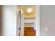 Bright walk-in closet with hardwood floors, shelves, and hanging rods at 421 Old Ride Dr, Holly Springs, NC 27540