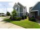 Well-maintained home exterior with green grass, landscaping, and lovely curb appeal at 421 Old Ride Dr, Holly Springs, NC 27540