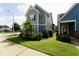 Well-maintained yard with lush green grass and neatly trimmed hedges, complementing the home's facade at 421 Old Ride Dr, Holly Springs, NC 27540