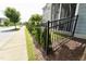 Exterior shot featuring an iron fence, manicured hedges, and a sidewalk at 421 Old Ride Dr, Holly Springs, NC 27540