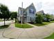 Inviting two-story home with neat lawn and flower beds, featuring an American flag by the front door at 421 Old Ride Dr, Holly Springs, NC 27540
