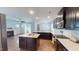 Bright kitchen space with a center island, stainless steel appliances, and hardwood floors, connecting to a cozy living room at 421 Old Ride Dr, Holly Springs, NC 27540