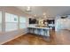Well-lit kitchen area with dark cabinetry, quartz countertops, stainless steel appliances and ample natural light from nearby windows at 421 Old Ride Dr, Holly Springs, NC 27540
