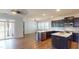 Modern kitchen with dark cabinetry, stainless steel appliances, and a convenient center island at 421 Old Ride Dr, Holly Springs, NC 27540