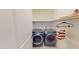 Convenient laundry room with side-by-side washer and dryer and hanging storage at 421 Old Ride Dr, Holly Springs, NC 27540