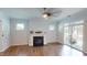 Inviting living room features a fireplace, hardwood floors, and a sliding door leading to an outdoor patio at 421 Old Ride Dr, Holly Springs, NC 27540