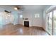 Cozy living room featuring a fireplace, hardwood floors, and plenty of natural light with sliding door to outdoor patio at 421 Old Ride Dr, Holly Springs, NC 27540