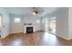 Bright living room features a fireplace, hardwood floors, and access to an outdoor patio at 421 Old Ride Dr, Holly Springs, NC 27540