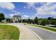 Charming community street view with inviting clubhouse and pool, perfect for leisurely living at 421 Old Ride Dr, Holly Springs, NC 27540