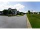 Wide street lined with attractive homes, green lawns, and mature trees, creating a welcoming neighborhood ambiance at 421 Old Ride Dr, Holly Springs, NC 27540