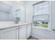 Bathroom with a white vanity, a large mirror, a window, and a view of the outdoors at 43 Salt Cedar Ln, Chapel Hill, NC 27516