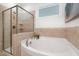 Bathroom with a soaking tub, glass-enclosed shower, and tile accents at 43 Salt Cedar Ln, Chapel Hill, NC 27516