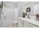 Bathroom featuring a shower-tub combo, white vanity, and framed artwork that accent the decor at 43 Salt Cedar Ln, Chapel Hill, NC 27516