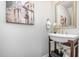 Charming powder room with unique pedestal sink, decorative mirror, and stylish artwork at 43 Salt Cedar Ln, Chapel Hill, NC 27516