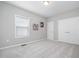 Bright bedroom featuring neutral walls, plush carpeting, double closets, and a window letting in natural light at 43 Salt Cedar Ln, Chapel Hill, NC 27516