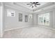 Serene bedroom featuring tray ceiling, neutral carpeting, and plantation shutters for a tranquil retreat at 43 Salt Cedar Ln, Chapel Hill, NC 27516